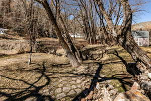 View of yard with an outbuilding and fence
