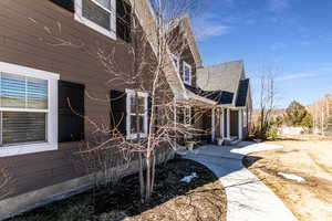 View of property exterior featuring a shingled roof