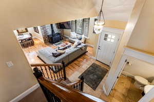 Foyer entrance featuring baseboards and a wood stove