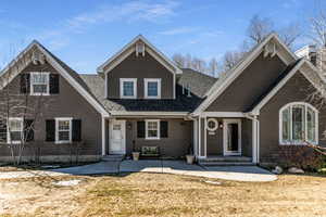 View of front of property featuring a shingled roof and entry steps
