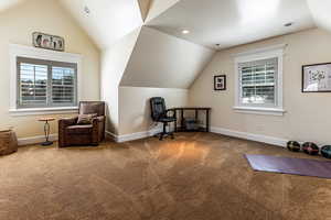 Living area with baseboards, carpet flooring, lofted ceiling, and recessed lighting
