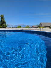 Pool featuring a mountain view and fence