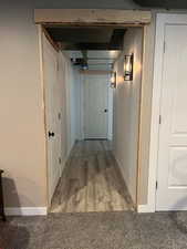 Hall with light wood-style flooring and baseboards