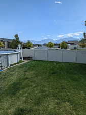 View of yard with a mountain view, a fenced backyard, and a fenced in pool