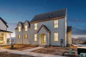 View of front of home with stucco siding and a shared courtyard
