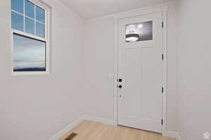 Interior space with baseboards, visible vents, and light wood-type flooring