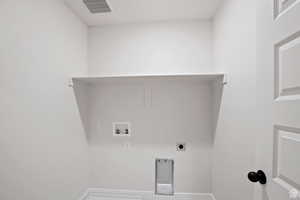 Laundry room featuring visible vents, laundry area, hookup for a washing machine, and electric dryer hookup