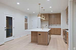 Kitchen featuring visible vents, light countertops, stainless steel range with gas cooktop, and a sink