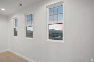 Unfurnished room with carpet flooring, plenty of natural light, baseboards, visible vents, and recessed lighting