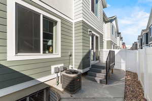 View of patio with central air condition unit and a fenced backyard