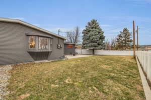 View of yard featuring a fenced backyard and a patio