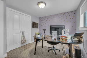 Office with baseboards, wallpapered walls, and carpet flooring