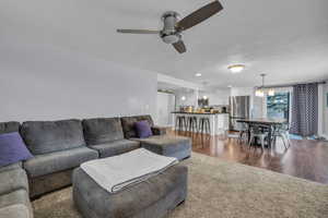 Living area featuring a textured ceiling, dark wood-style floors, recessed lighting, and ceiling fan