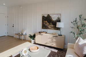 Living room with a decorative wall and wood finished floors