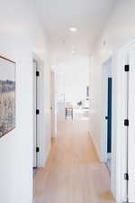 Hall featuring baseboards and light wood-style flooring