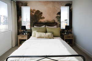 Carpeted bedroom featuring baseboards
