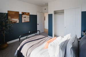 Bedroom with baseboards, visible vents, a closet, and carpet flooring