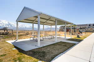 View of property's community with a gazebo, playground community, a patio, and a mountain view