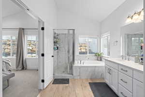 SPA bathroom featuring separate shower/tub, private vanities, and vaulted ceilings