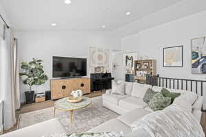 Spacious living room area.  Furniture with vaulted ceilings and views of the backyard