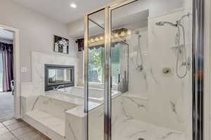 Owners En Suite Bathroom - Separate Tub and  Seated Shower with Double Sided Fireplace