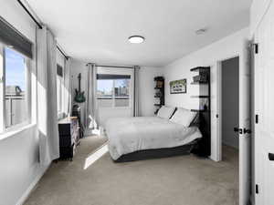 Carpeted bedroom featuring baseboards