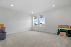 Rec room with carpet floors, baseboards, visible vents, and recessed lighting