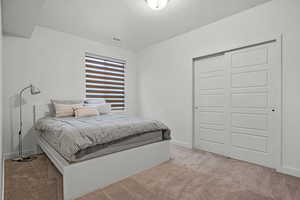 Bedroom featuring baseboards, a textured ceiling, carpet floors, visible vents, and a closet