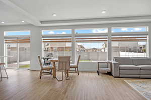 Dining space featuring baseboards, wood finished floors, recessed lighting, and a textured ceiling