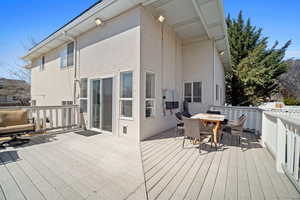Wooden deck featuring outdoor dining area