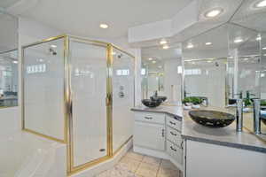 Full bath featuring vanity, recessed lighting, a shower stall, tile patterned floors, and a garden tub