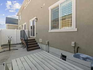 Exterior space featuring stucco siding, fence, central AC, and a patio area
