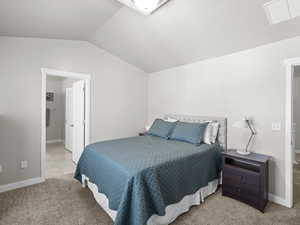 Bedroom featuring carpet flooring, baseboards, vaulted ceiling, and visible vents