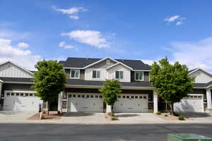 Craftsman-style home with board and batten siding, an attached garage, and concrete driveway