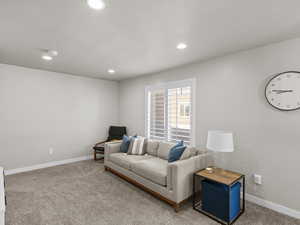 Living area featuring carpet floors, baseboards, and recessed lighting