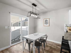 Dining area with baseboards and light wood-type flooring