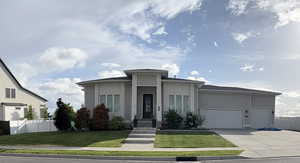 View of front of home with a garage and driveway