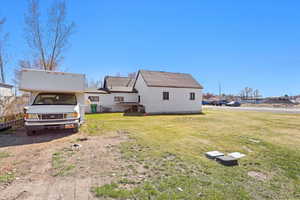 Back of property featuring a lawn