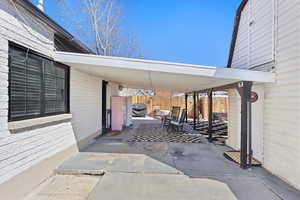 View of patio / terrace featuring grilling area, an attached carport, and fence
