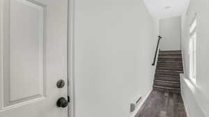 Stairs featuring wood finished floors