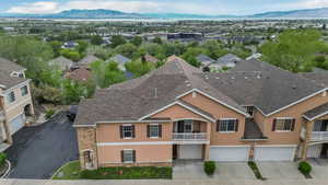Aerial view of property and surrounding area with a mountain backdrop