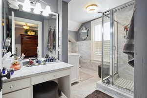 Full bathroom featuring lofted ceiling, visible vents, a stall shower, vanity, and marble finish floor