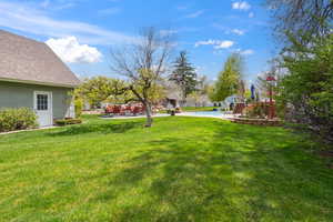 View of yard featuring a patio and a fenced in pool