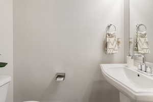 Half bath with a sink and toilet