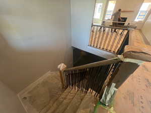 Stairs featuring baseboards and plenty of natural light