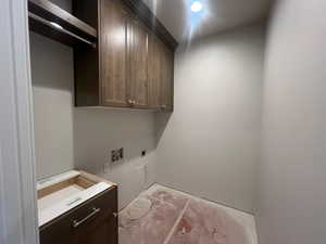 Laundry area with cabinet space and electric dryer hookup