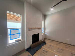 Unfurnished living room with a brick fireplace