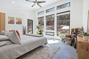 Bedroom with recessed lighting, a ceiling fan, and finished concrete floors