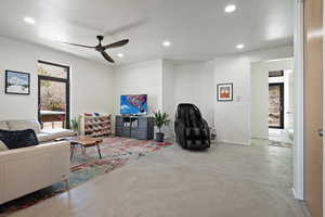 Living area featuring concrete floors, recessed lighting, and a ceiling fan