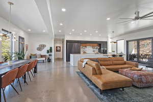 Living room featuring concrete flooring, ceiling fan, and recessed lighting